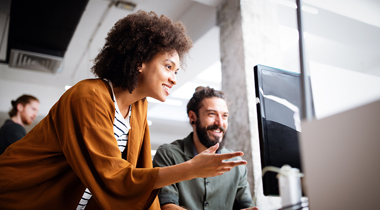 Two employees look at pre-employment testing results online. 