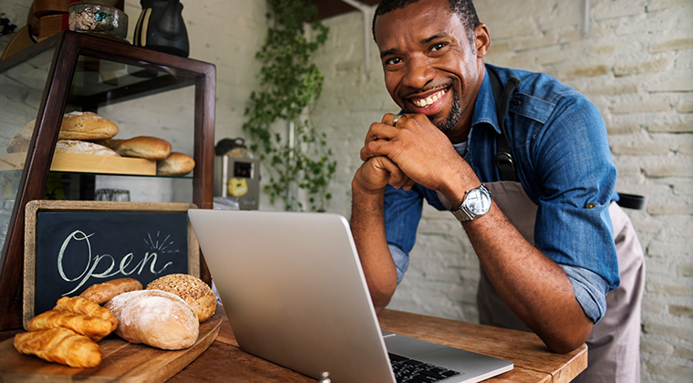 A hospitality manager smiles because he's gotten help with some of his biggest hiring challenges. 