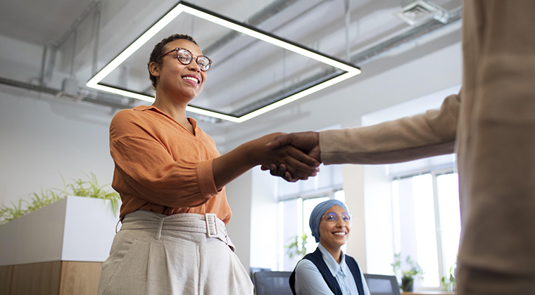 A happy SaaS customer shakes hands over a new private label partnership.