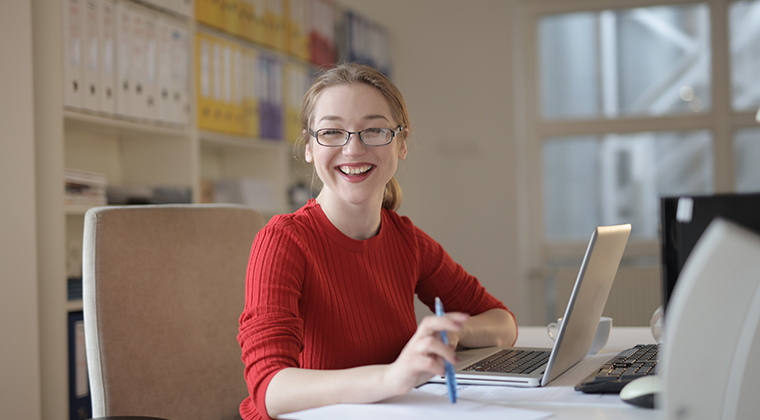 A happy job candidate smiles during her culture-add interview, seeing as it's more inclusive than the traditional culture-fit.