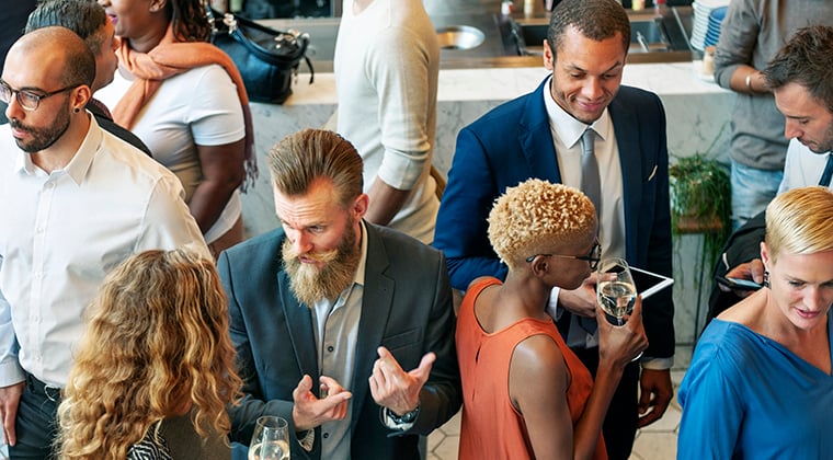 Recruiters mix with both active and passive job candidates at a professional networking event. 