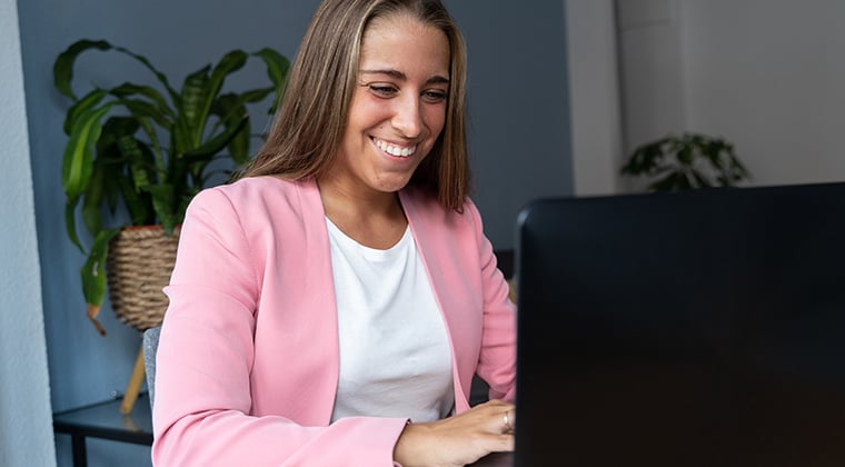 Woman in pink jacket writing a job description