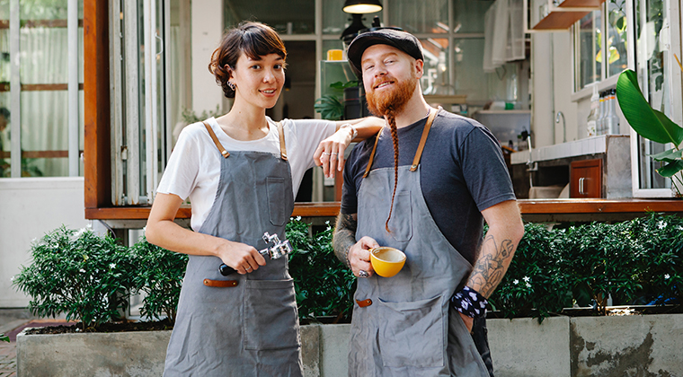 Two employees of a multi-location business (a coffee shop) chat about the benefits of their ATS.