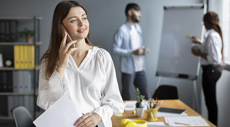 A happy ATS user smiles while on the phone