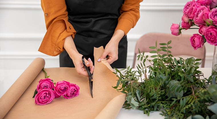 Florist prepare to wrap an arrangement